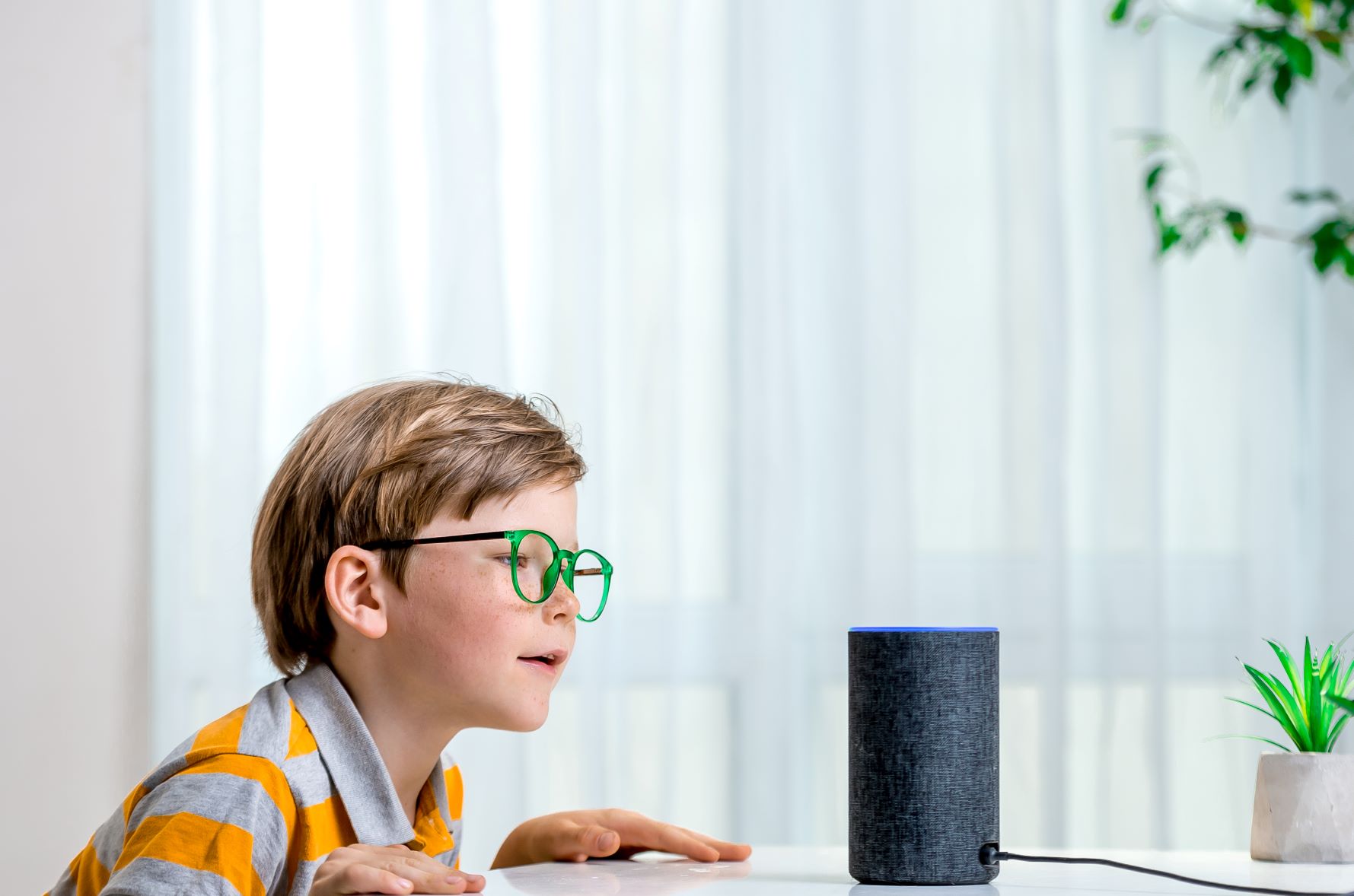 child using Amazon Alexa; smart home entertainment system